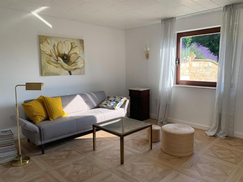 a living room with a couch and a table at Refugium - central, quiet apartment with terrace in Frankenberg