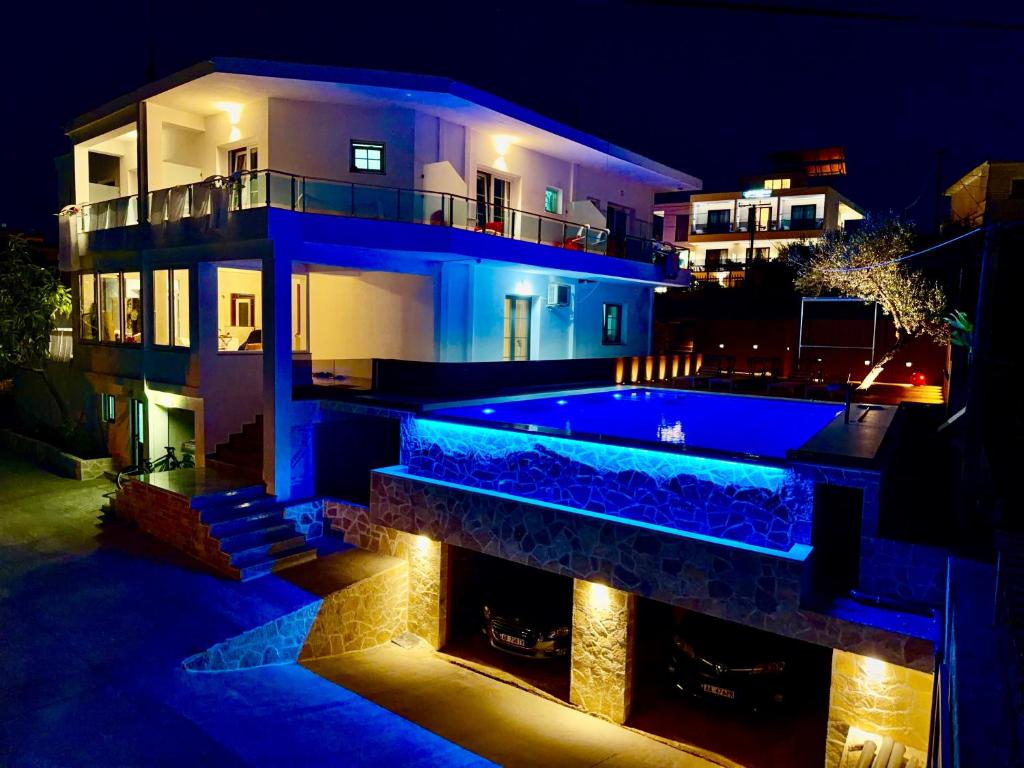 a house with a swimming pool at night at Villa Abiori in Ksamil
