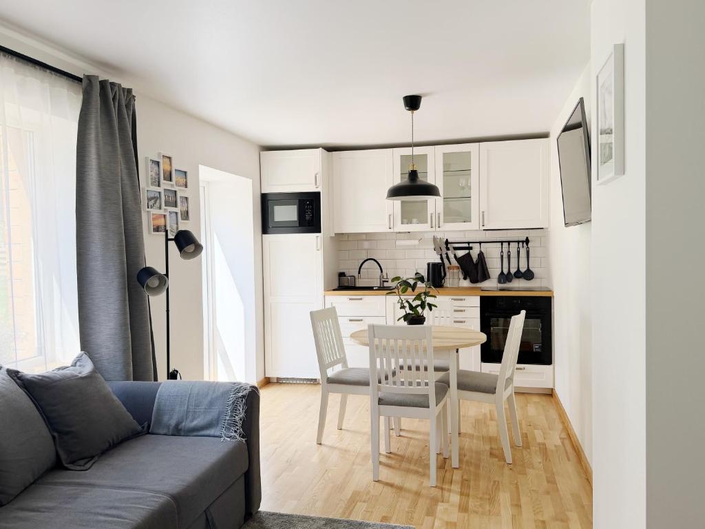 a living room with a table and a kitchen at Liedagas in Kolka