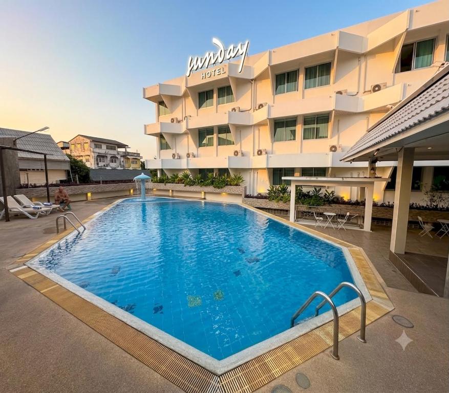 a large swimming pool in front of a hotel at Sunday Ayothaya Hotel in Phra Nakhon Si Ayutthaya