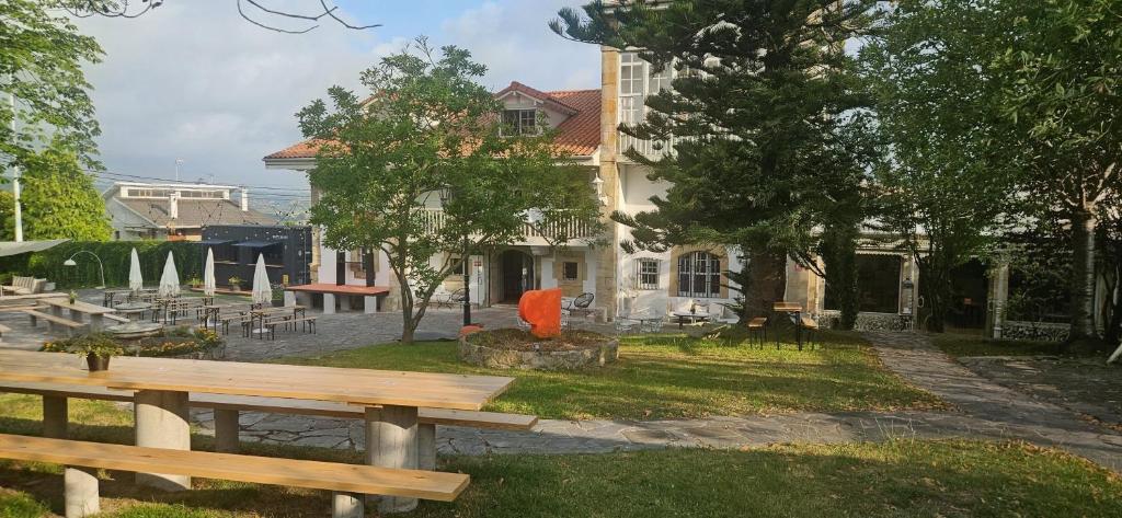 a park with a bench in front of a building at Planazo House in Arnuero