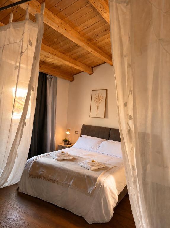 a bedroom with a large bed with mosquito nets at Locanda di Ody in Pietra Montecorvino