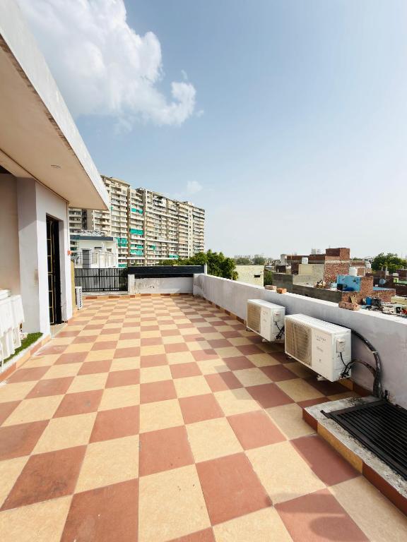 a balcony with a checkered floor on a building at Sirtaj Suites in Tājganj