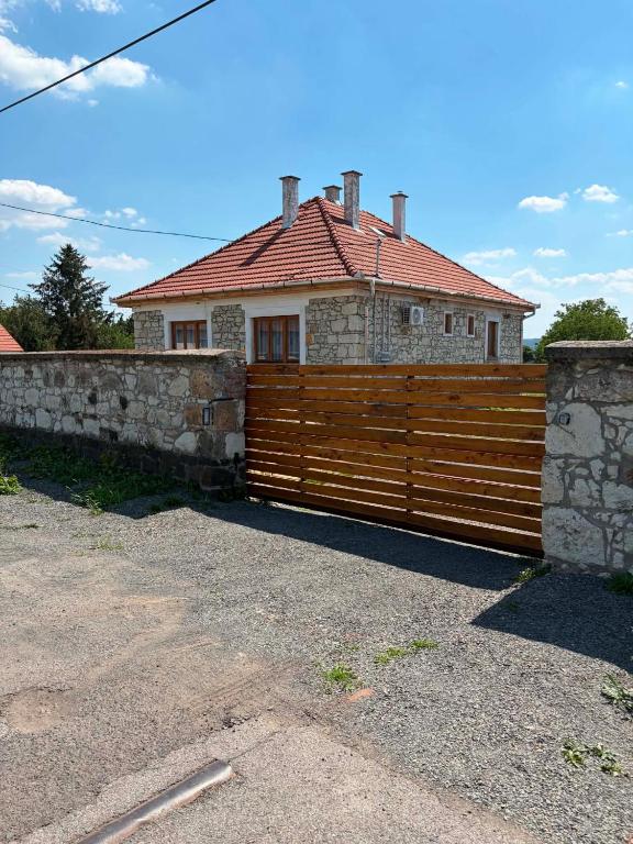 a wooden fence in front of a house at WINE NOT Tállya in Tállya