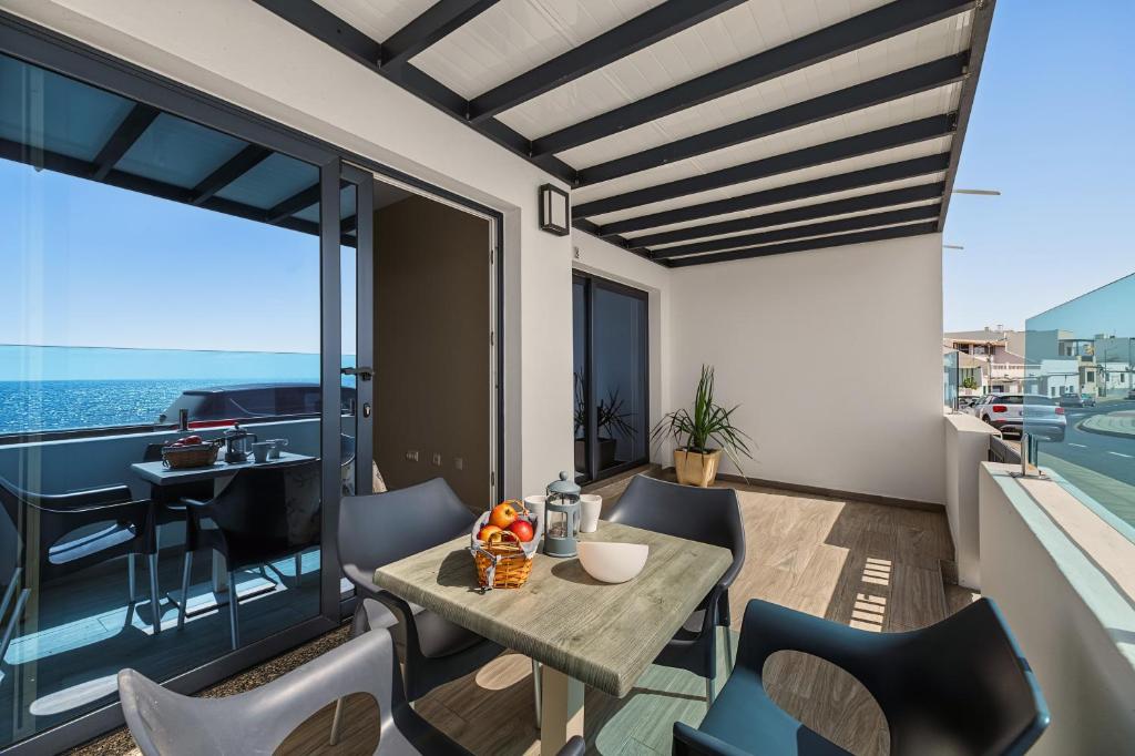a balcony with a table and chairs and a view of the ocean at Callao Beach 3 in Arrieta