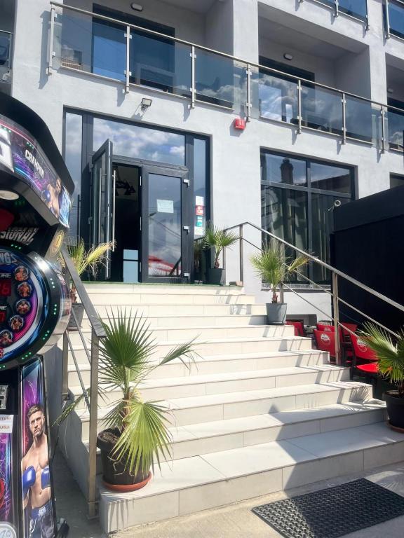 a building with stairs and potted plants on it at Diamonds in the Sky in Costinesti