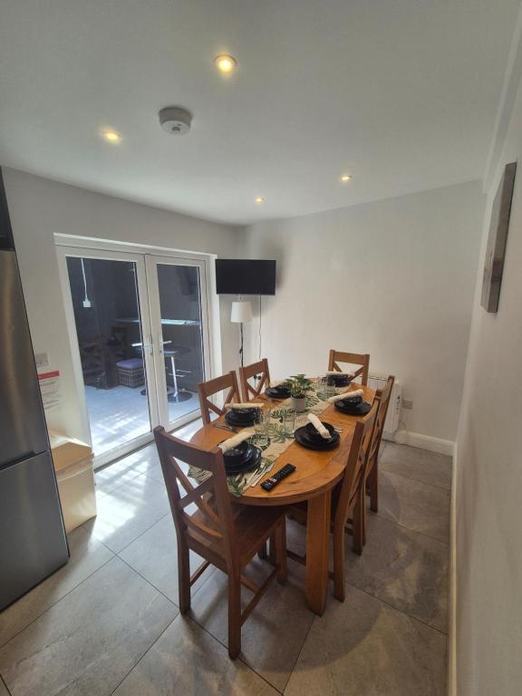 a dining room with a wooden table and chairs at 3 Eyre Square Lane in Galway