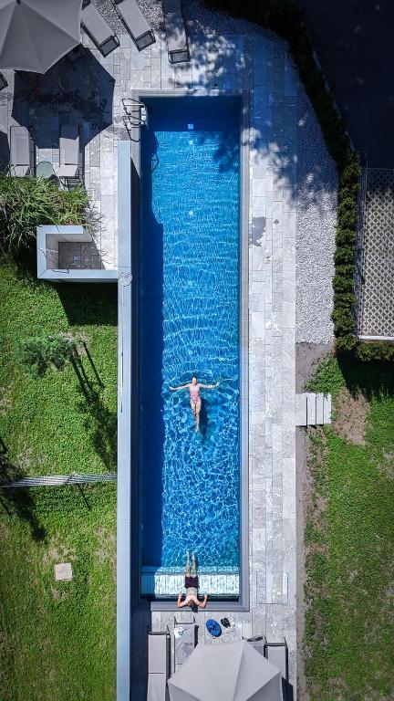a person swimming in a swimming pool in a swimming pool at Revier Boutique Hotel Kaprun in Kaprun