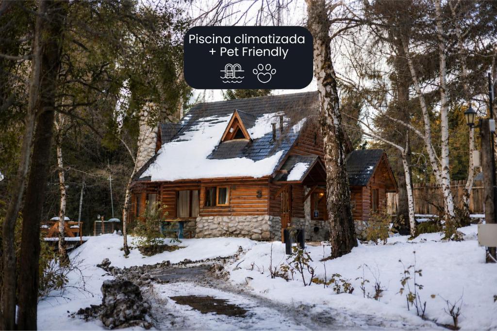a log cabin in the woods in the snow at Ruma Andina by DOT Cabana in Villa La Angostura
