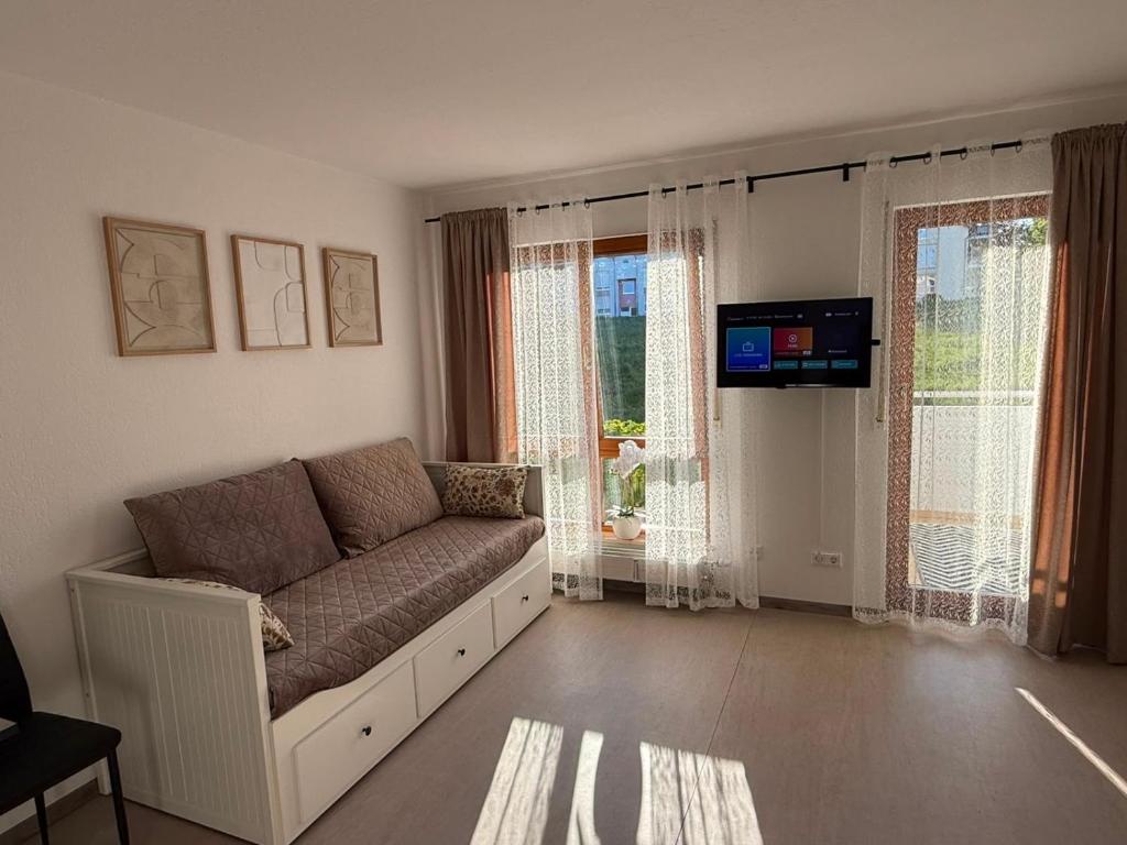 a living room with a couch and a television at Apartment Eppingen in Eppingen