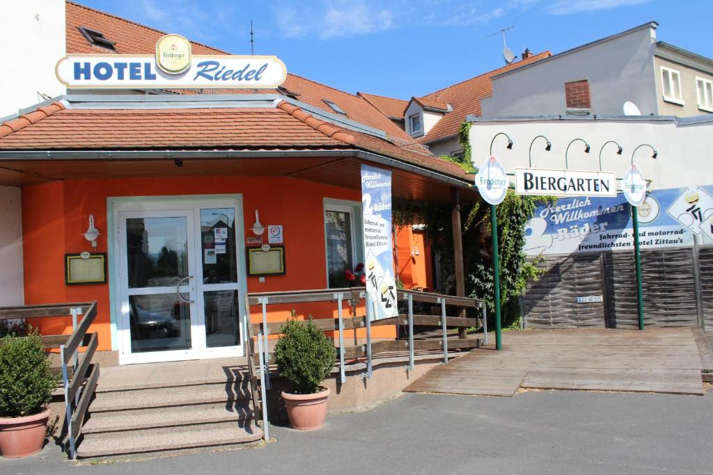 a hotel building with a sign in front of it at Hotel Riedel in Zittau