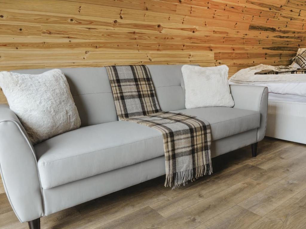 a couch and a chair in a room at Islay - Uk48416 in Dalry