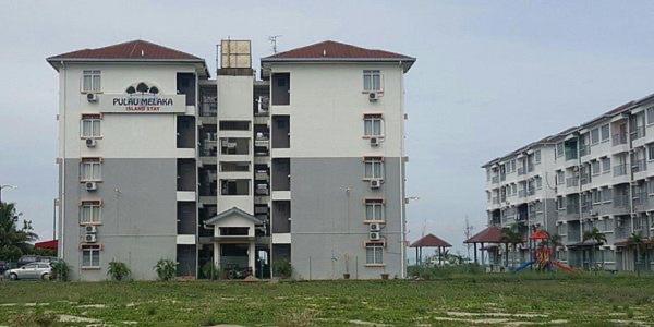 a large building with a car parked in front of it at Homestay PANDAN 10 PULAU MELAKA in Malacca