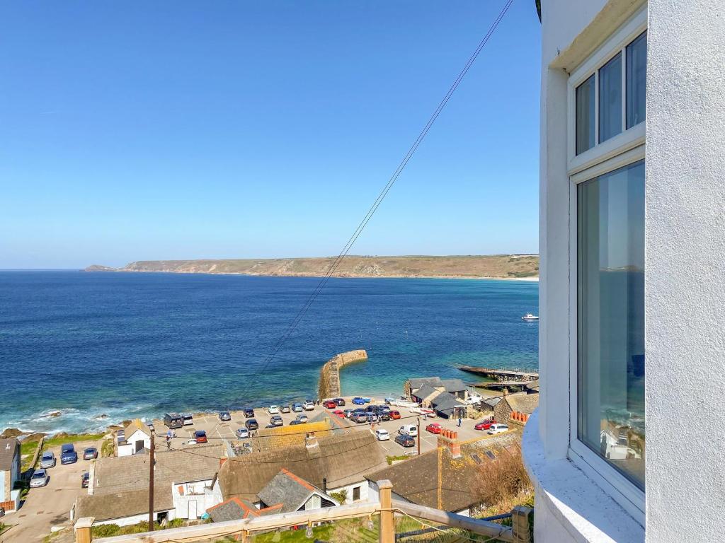 a view of a beach from a window of a building at The Lookout in Sennen