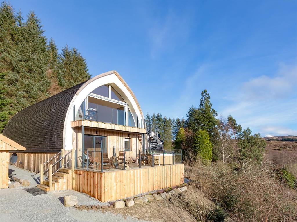 a house with a large window on the side of it at Jill Strawbale House- Ukc2935 in Strontian