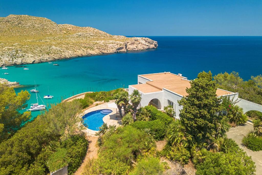 an aerial view of a house on a hill next to the water at Villa Casa Blanca Carbo by Sealand Villas in Cala de Sant Vicenc