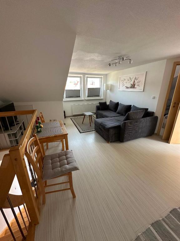 a living room with a black couch and a table at Ferienwohnung Litau in Sonthofen