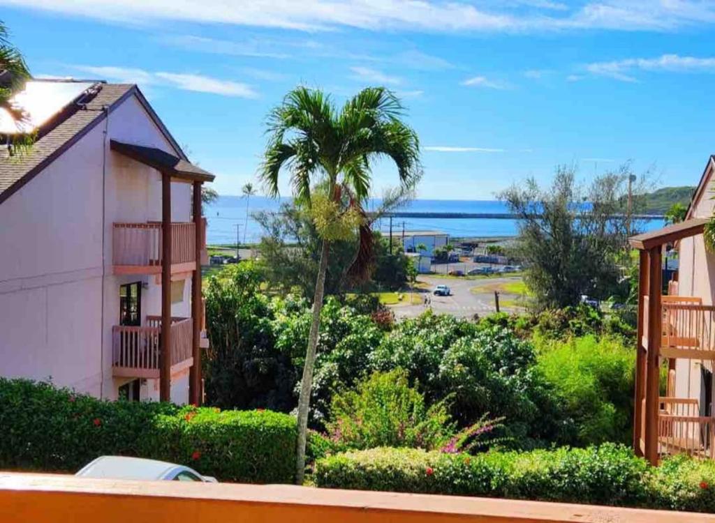 a view of the ocean from a house at Central and Bright 2 BR, 2 BA, Pool and Oceanview in Lihue