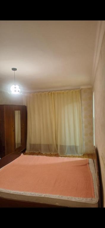 a bed in a small room with a window at Ma ry in Jvari
