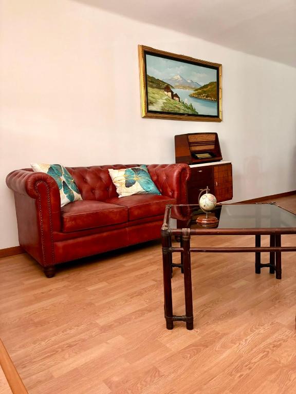 a living room with a red couch and a table at I Due Timidi in Putignano