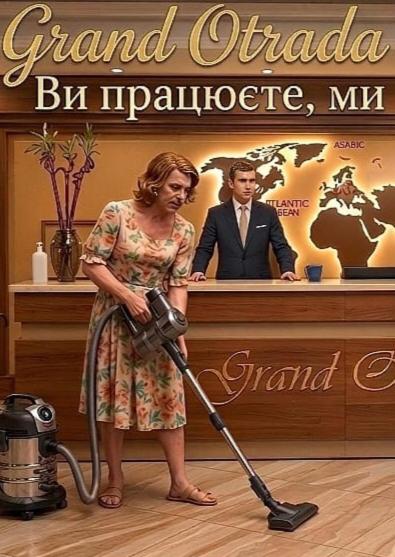 a woman using a vacuum cleaner in front of a counter at GRAND OTRADA Hotel Resort & SPA in Odesa