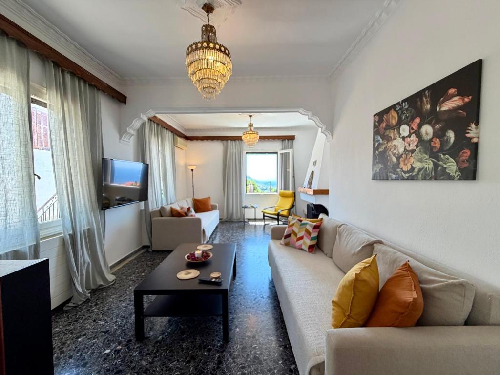 a living room with a couch and a table at Demie and George Ηouse in Loutraki