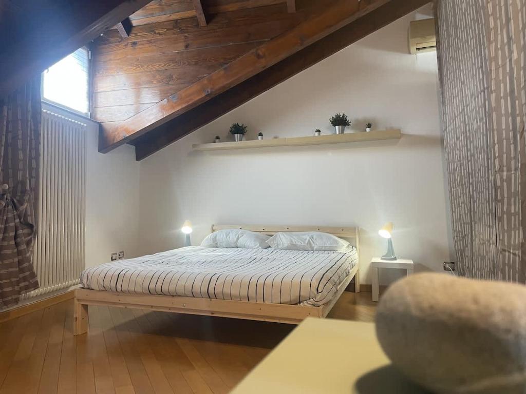 a bedroom with a bed with a wooden ceiling at Viale Monza Chic Stay - Affitti Brevi Italia in Milan
