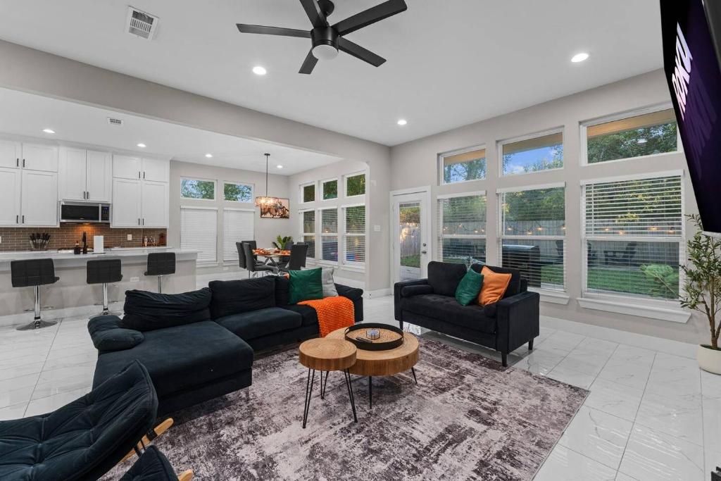 a large living room with couches and a kitchen at Lux, Fenced Backyard 4 Pets, Firepit, Exec Desk in Dallas