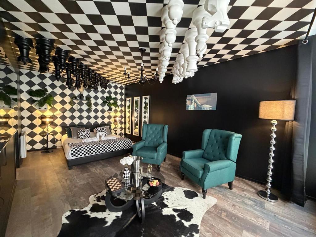 a living room with two chairs and a couch at L'échiquier royal-Studio chic proche château fort in Sedan