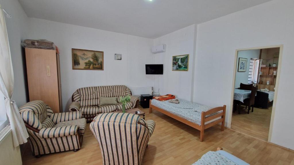 a living room with two chairs and a table at Aleksinac Centar Two-Bedroom Apartment in Aleksinac