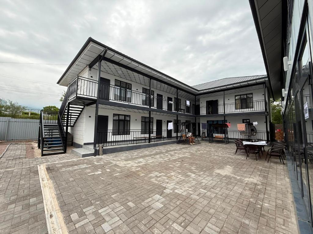 a large building with a patio and a staircase at Edelweiss 2 in Bosteri