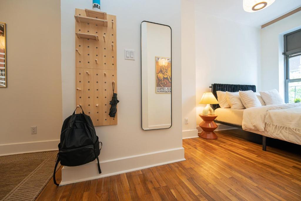 a bedroom with a mirror and a bed and a couch at Lamartine Chelsea in New York