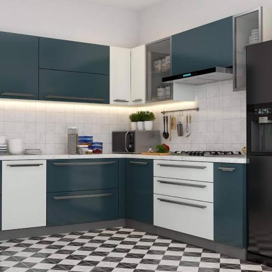 a kitchen with blue cabinets and a checkered floor at The palace lanka in Yakwala