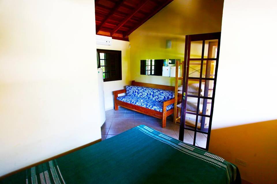 a living room with a blue couch in a room at Chales Maresias in Maresias