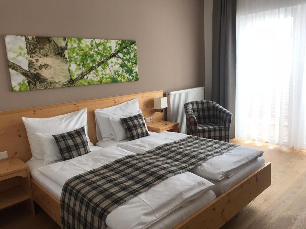 a bedroom with a bed with a checkered blanket at Gasthof Wachter in Gaal
