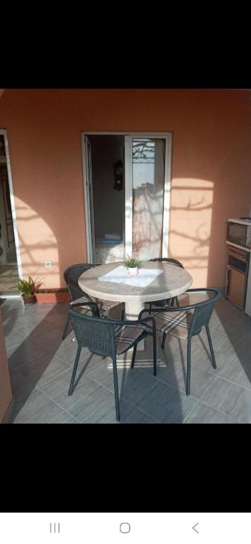 Ein Tisch und Stühle stehen auf einer Terrasse in der Unterkunft Zagaa1 in Petrovac na Moru