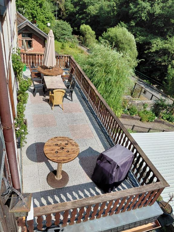 a patio with a table and chairs and an umbrella at Rurterasse in Monschau