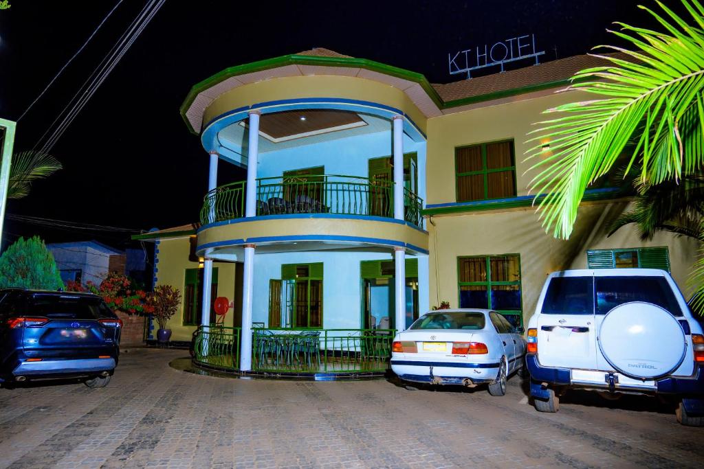 a house with two cars parked in front of it at KEFA Town Hotel in Kigali