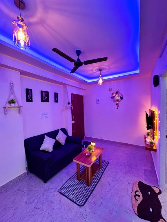 a living room with a couch and a table at Namma Suites cozy 1BHK Stay Near Koramangala BTM layout in Bangalore