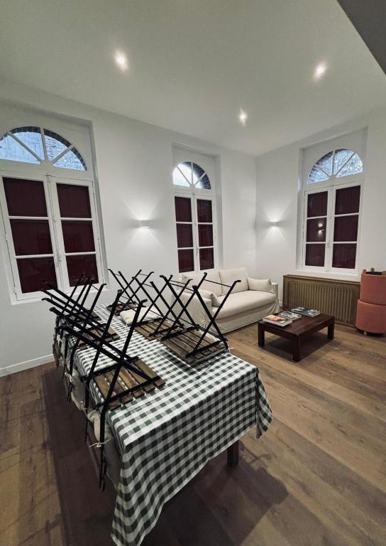 a living room with a couch and a table at Les gîtes in Daubeuf-Serville