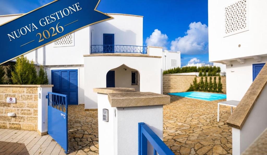 a white house with blue doors and a sign that reads moulin extension at Quintino Apartments Pool in Torre Lapillo