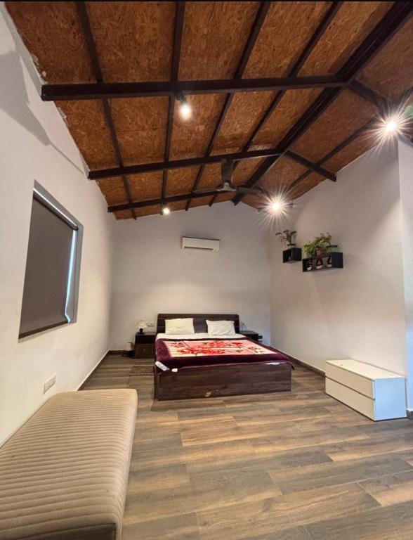 a bedroom with a bed and a flat screen tv at Rathi property in Gurgaon