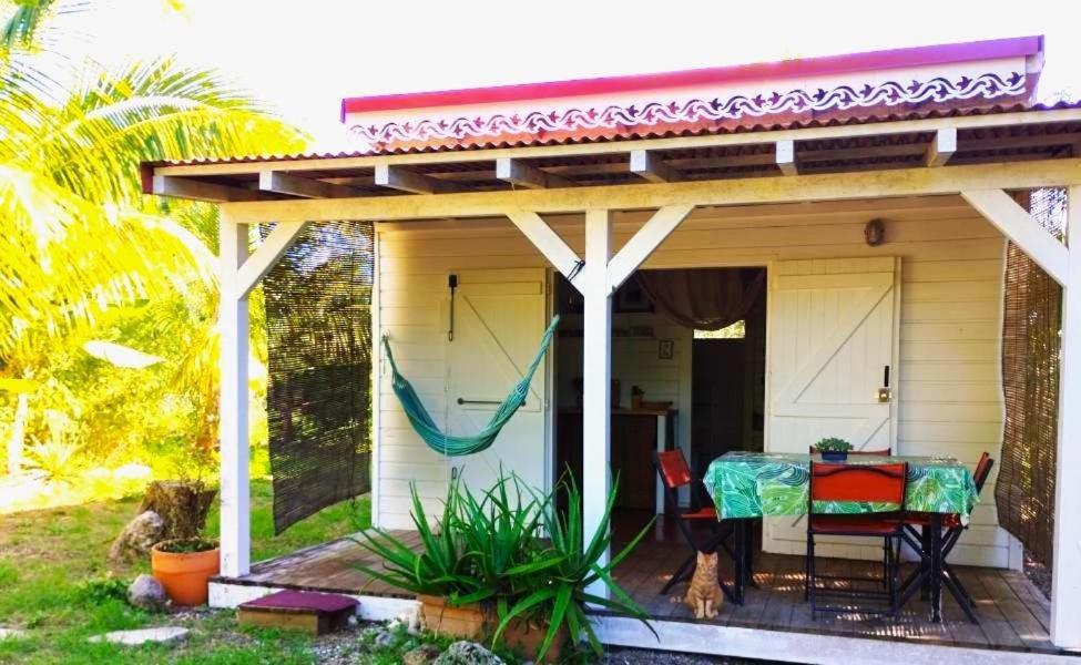 a porch of a house with a table and chairs at Kaz Menard in Saint-Louis
