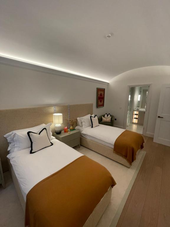 a hotel room with two beds and a window at The City Hotel London in London