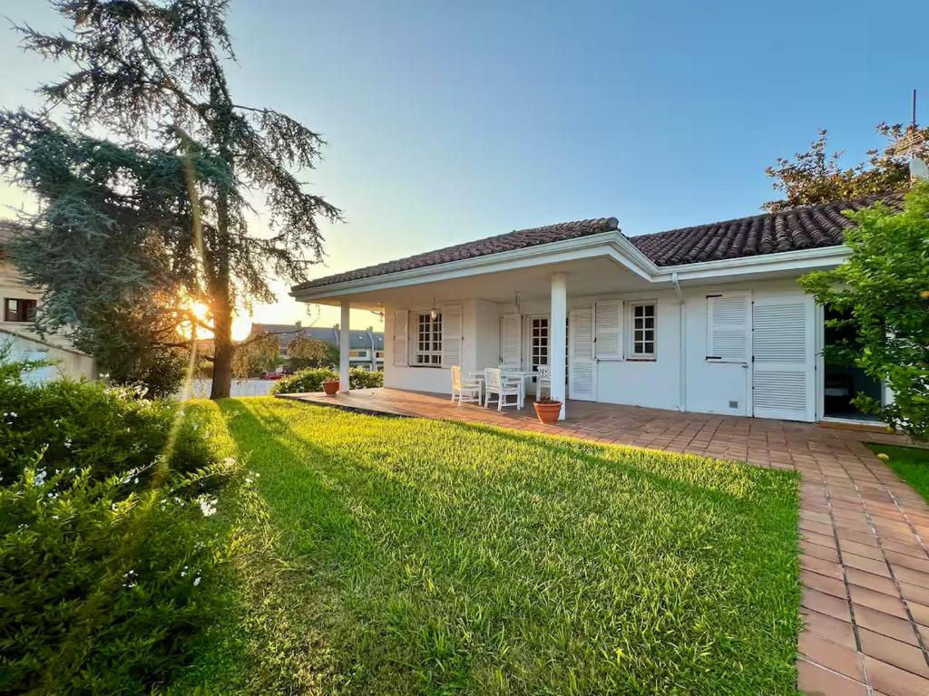 a white house with a lawn in front of it at Casa Sierrapando - by Wehomes in Torrelavega