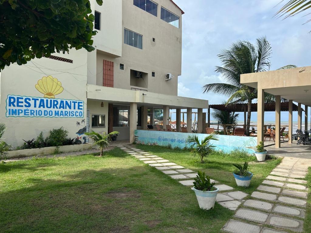 a building with a sign on the side of it at Pousada e Restaurante Império do Marisco in Maragogi