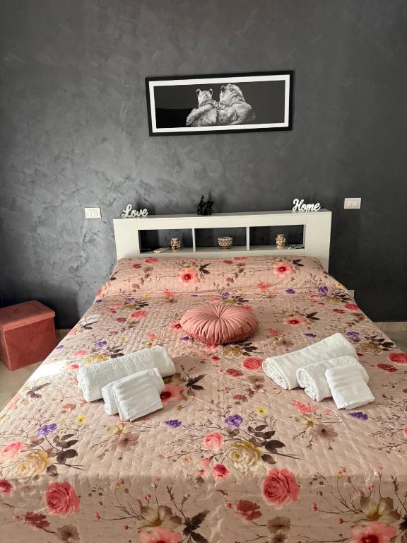 a bedroom with a bed with a floral bedspread at Maison D'orleans By Catalano in Palermo