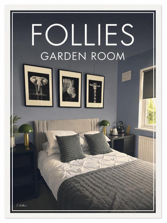 a bedroom with a bed with four pictures on the wall at Follies Garden Room in Dungarvan