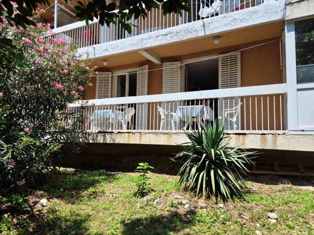 a balcony of a house with chairs and flowers at Drača in Savina