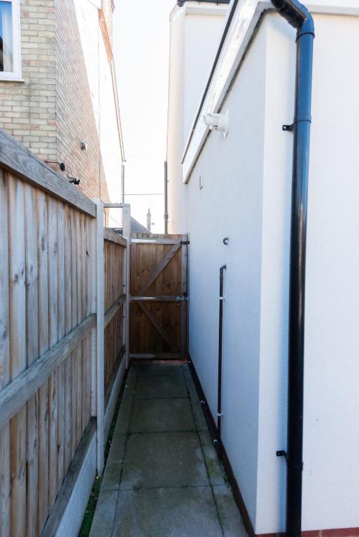 a gate to a house with a wooden fence at 4BR Braintree Contractor - long stay in Braintree